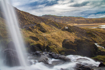Behind a Waterfall in Island - Waterfall with Mountains, Sky and Clouds
