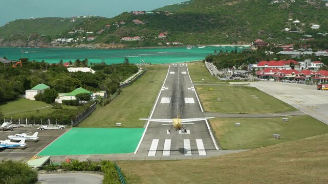 Motion video of airplane landing at famous airport - saint Barthelemy island (Gustav III airport).