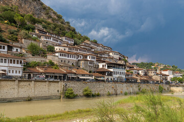 Obraz premium Sunset over the UNESCO town of Berat on the Osum River in Albania and known for its white Ottoman houses also called the city of One Over One Windows and built against the hill side below the citadel