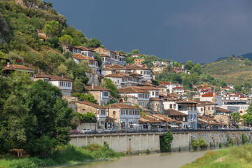 Naklejka premium Sunset over the UNESCO town of Berat on the Osum River in Albania and known for its white Ottoman houses also called the city of One Over One Windows and built against the hill side below the citadel