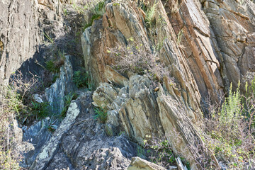 Rocky slope of the mountain on a sunny day close-up