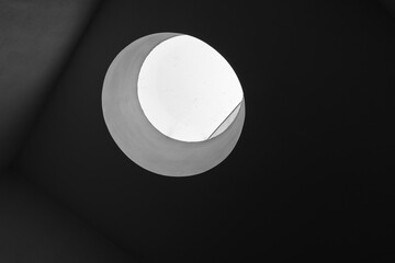 Round skylight portal with bright sky behind, abstract minimal photo