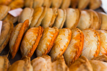 fFeshly baked empanadas with different fillings for sale