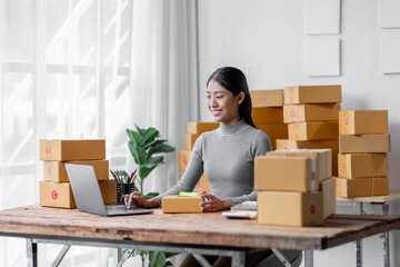 Attractive young freelancer SME owners asian woman entrepreneurs working on receipt box and check...