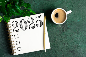 New year resolutions 2025 on desk. 2025 resolutions list with notebook, coffee cup on table. Goals,...
