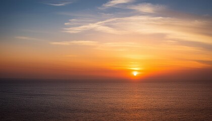 Obraz premium A breathtaking desert sunset with golden dunes bathed in warm light, creating a serene and vast landscape.