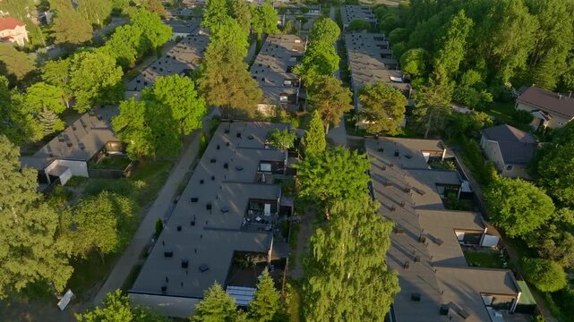 Aerial tracking shot of rowhouses, summer evening in the suburbs of Helsinki