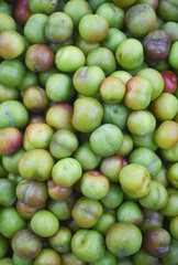 green plums in the market
