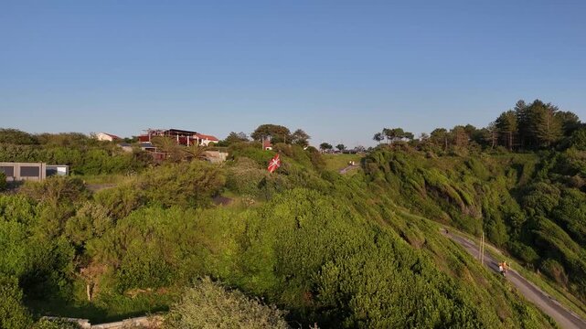 Ikurri&ntilde;a at the top of a cliff at the Lafitenia beach, near Donibane Lohizune-Saint Jean de Luz, Basque Country.