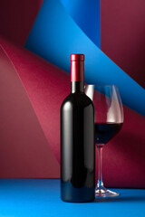 Bottle and glass of red wine.