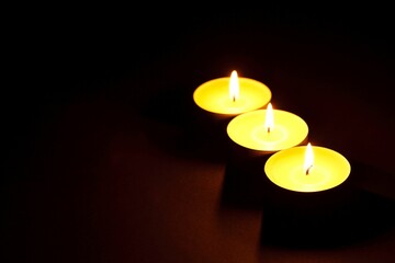 Burning Candles in Blackness - Grouped Together on Dark Background in 4K image