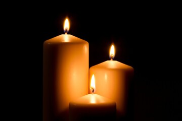 Burning Candles in Blackness - Grouped Together on Dark Background in 4K Video
