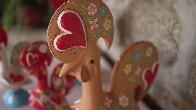 Barcelos rooster figurine with heart and floral designs, symbolizing Portuguese folklore.
