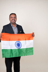 A proud gentleman holding the Indian flag, symbolizing patriotism and national pride.