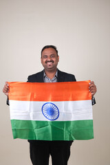 A proud gentleman holding the Indian flag, symbolizing patriotism and national pride.