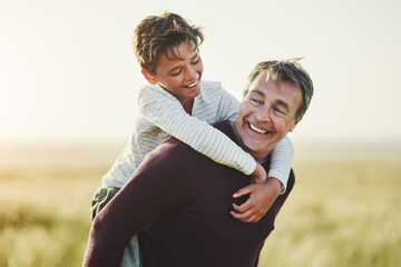 Countryside, father and carrying of son in nature, love and smile for family in space, sunshine and grass. Outdoor, dad and visit of Texas with boy for fresh air, man and bonding with child in farm