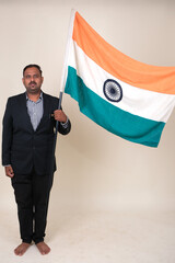 A proud gentleman holding the Indian flag, symbolizing patriotism and national pride.