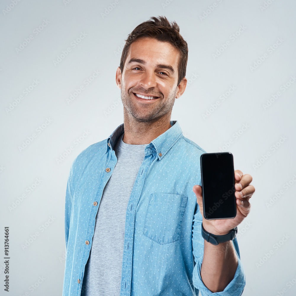 Poster advertising, phone screen and portrait with smile of man in studio on white background for communica
