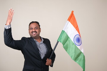 A proud gentleman holding the Indian flag, symbolizing patriotism and national pride.