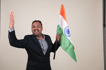 A proud gentleman holding the Indian flag, symbolizing patriotism and national pride.