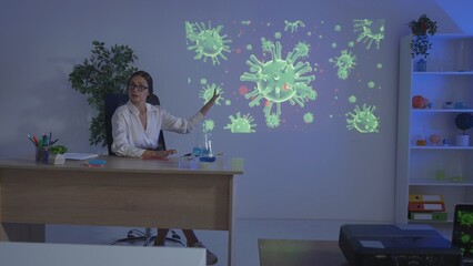 Junior school children in classroom on science chemistry lesson. Teacher shows petri dish, explains video footage on projector. Modern education concept