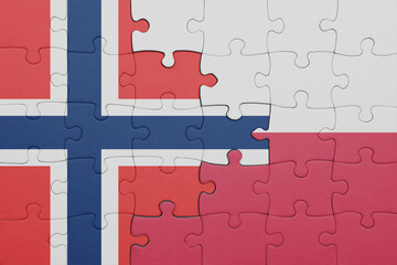 puzzle with the colourful national flag of poland and flag of norway .
