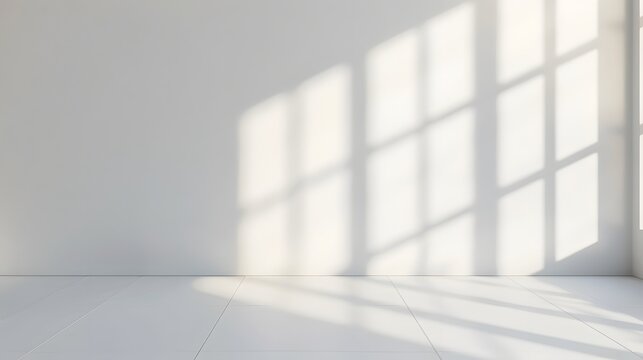 A bright white room with light shining through the window, casting soft shadows on an empty wall. creating an abstract and minimalist background for product display or presentation