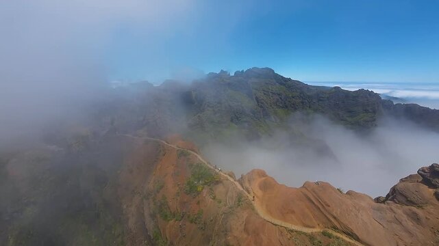 Rainbow in lush valley on Madeira Island. Discover the Pico do Pico trail through dynamic drone footage. Perfect for showcasing diverse landscapes in travel and nature content.