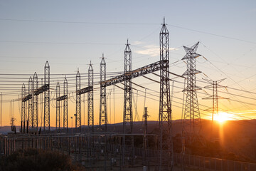 Sunset silhouette of hydroelectric power plant infrastructure