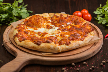 khachapuri with sulguni cheese, herbs and egg on a wooden surface. Georgian pie. Georgian pizza
