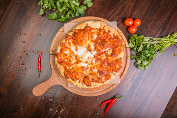 khachapuri with sulguni cheese, herbs and egg on a wooden surface. Georgian pie. Georgian pizza

