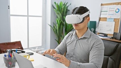 A young asian man wearing a virtual reality headset and gesturing in a modern office setting.