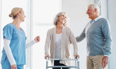 Obraz premium Caregiver, walking and senior patient with walker, old couple and compassion for elderly woman with disability. Clinic, nurse and grandma with husband, care and support for healthcare and wellness