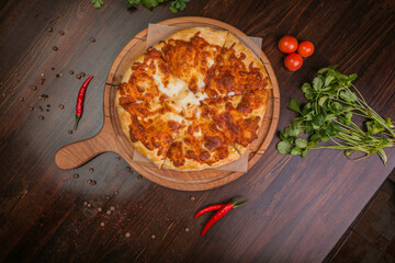 khachapuri with sulguni cheese, herbs and egg on a wooden surface. Georgian pie. Georgian pizza
