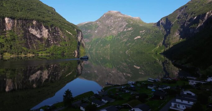 Aerial View Above Cabins in Geirangerfjord as Ferry brings Tourists on Fjord Cruise from Geiranger to Hellesylt, Norway. Top Norwegian Travel Destination