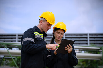 Blue collar workers are working at refinery factory.