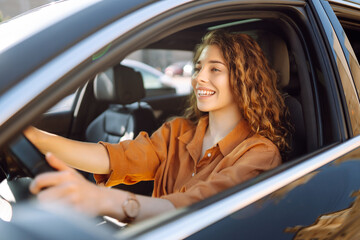 Portrait young woman driving car. Young traveler driving. Car travel, lifestyle concept.