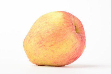 Fresh ripe apple with tiny water drops on white background