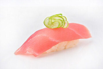 Raw fish sushi topped with Japanese scallions, ready to eat.