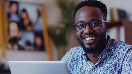 Obraz premium Happy Man in Glasses Working on Laptop