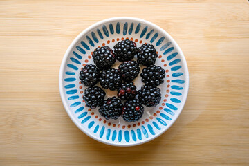Fresh ripe blackberries on wooden table. Space for text