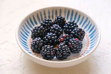 Fresh ripe blackberries on wooden table. Space for text