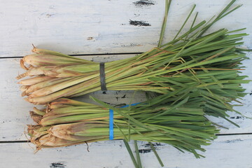 Two bunches of lemongrass on a wooden table

