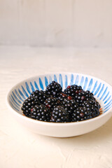 Fresh ripe blackberries on wooden table. Space for text