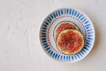 Beautiful fresh sliced black figs on white background