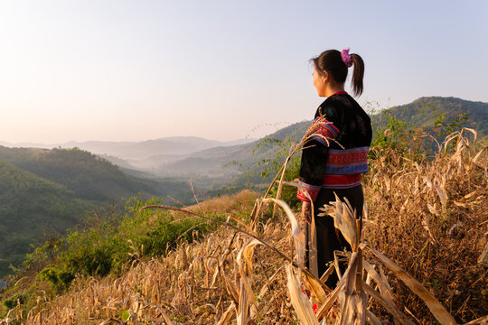 Woman of Lisu tribe looking at landscape at sunrise, Chiang Rai, Thailand