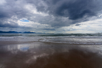 A dark, cloudy spring afternoon on Llanddwyn beach, Anglesey, Wales.