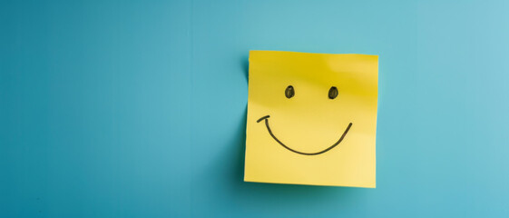 Yellow sticky note with a hand-drawn smiley face on a minimalist blue background, conveying joy, simplicity, and positivity in a cheerful and bright composition.