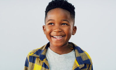 Thinking, smile and black child in studio for fashion, excited and summer fun. Young kid, happy and idea on white background for positive energy, confident or school profile update in Nigeria