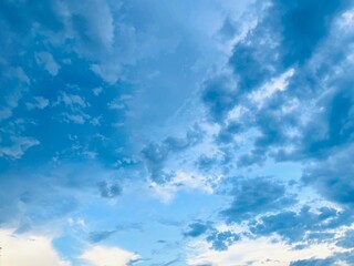 Obraz premium bright blue sky decorated with a few clouds and sunlight